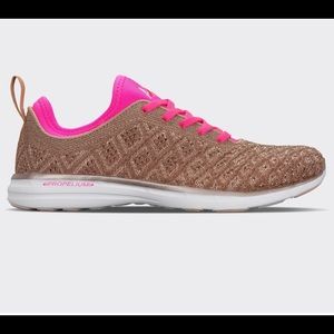 Selling:running shoes. Brand: APL Color:hot pink and rose gold.